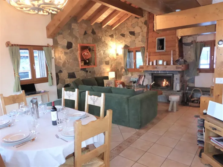 A living room that is both very warm and open to the mountains