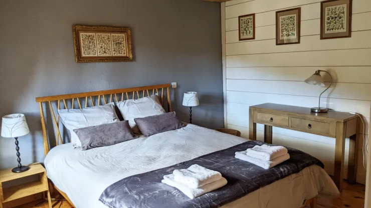 The master bedroom with a king size bed, overlooking the garden and the mountains