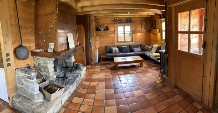 The living room is a space for all exchanges and sharing : a large open fireplace made of local stone, original terracotta floor tiles, and walls and ceilings entirely crafted from authentic wood...! In the crackling warmth of a good fire, you'll create u