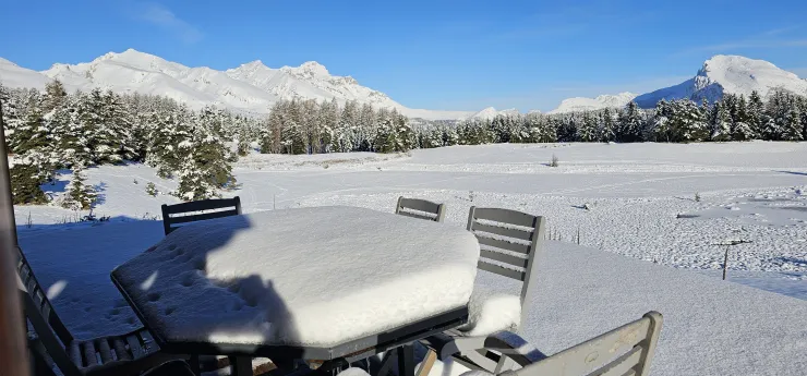 Snow-covered terrace with mountain views