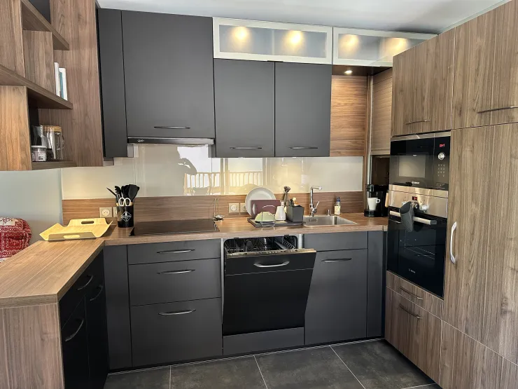 Fully equipped kitchen with dishwasher, oven, microwave, large refrigerator, and freezer space.
