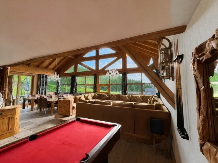 Large U-shaped corner sofa under a 5-meter-high cathedral ceiling, a pool table, and a dining room that seats 22 people